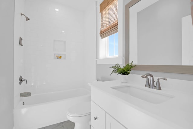 full bathroom featuring vanity, toilet, and tiled shower / bath