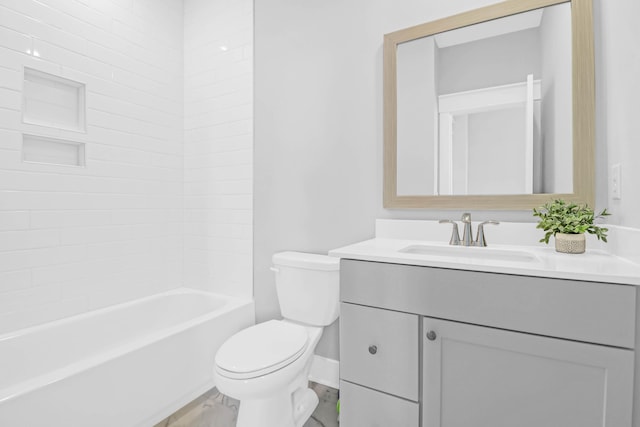 full bathroom featuring tiled shower / bath, vanity, and toilet