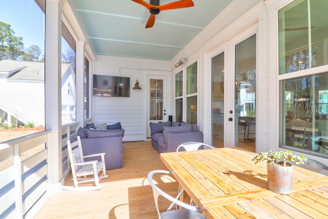 sunroom / solarium featuring ceiling fan