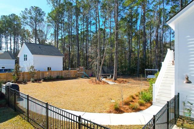 view of yard featuring a playground and a trampoline