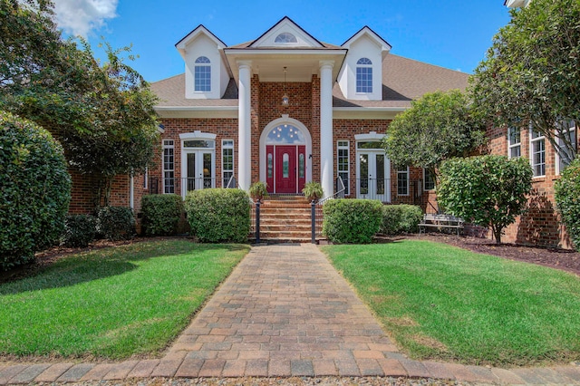 view of front of house featuring french doors and a front lawn