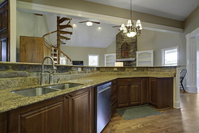 kitchen with a sink, a wealth of natural light, wood finished floors, and dishwasher