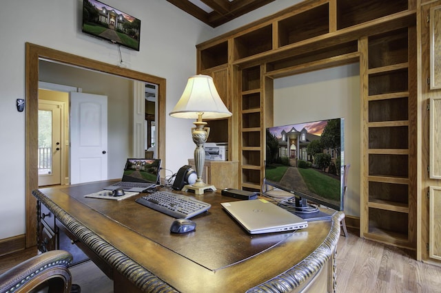 office space with baseboards and light wood-style floors