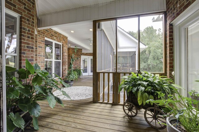 sunroom / solarium featuring french doors