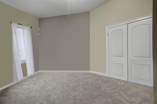 unfurnished bedroom featuring baseboards, a closet, and carpet
