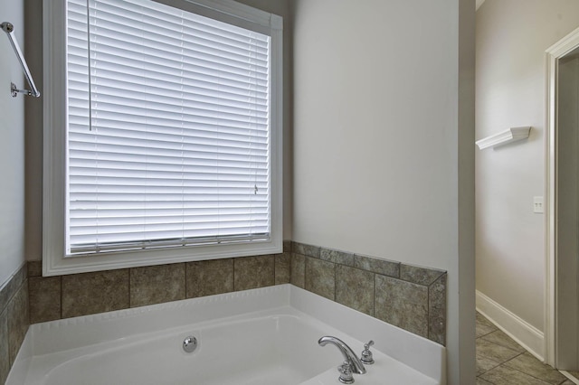 full bath featuring a garden tub and tile patterned floors