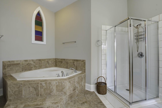 bathroom with a stall shower, tile patterned flooring, and a garden tub