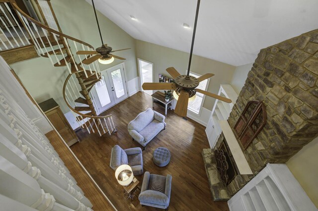 living area featuring wood finished floors, a healthy amount of sunlight, and a ceiling fan