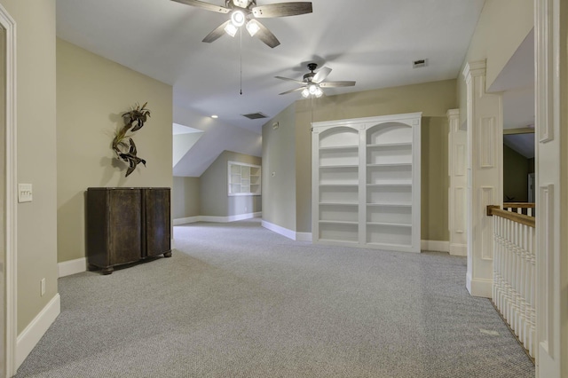 additional living space featuring lofted ceiling, baseboards, carpet floors, visible vents, and a ceiling fan