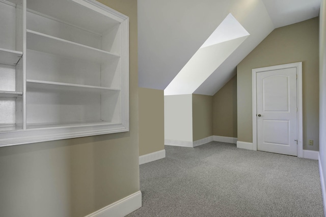 bonus room with baseboards, carpet floors, and lofted ceiling
