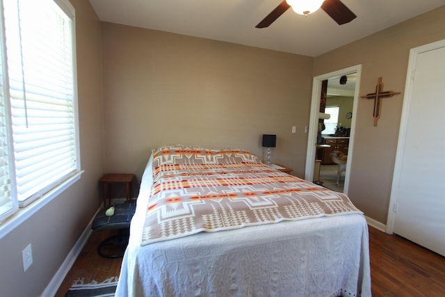 bedroom with ceiling fan, baseboards, and wood finished floors