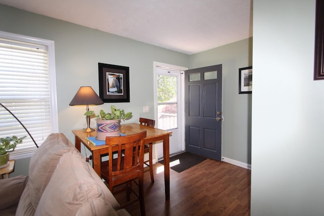 foyer featuring dark wood-style floors and baseboards