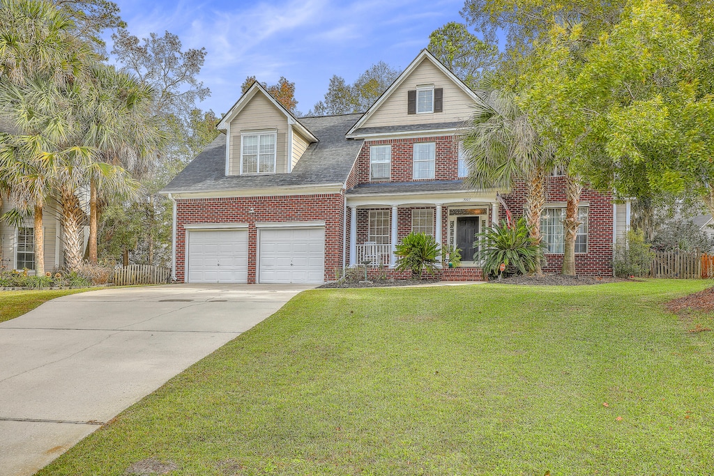 view of front of property with a garage and a front yard