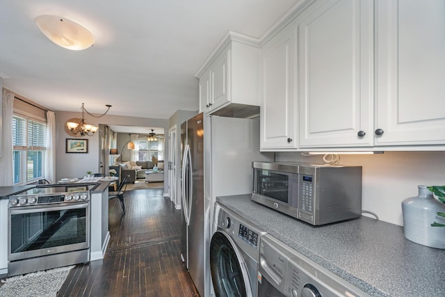 kitchen featuring white cabinets, dark countertops, dark wood-style floors, washer / clothes dryer, and stainless steel appliances