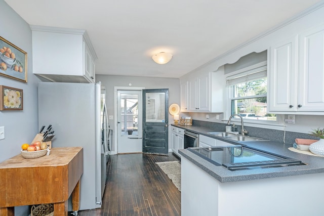 kitchen featuring white cabinets, dishwashing machine, dark wood-style flooring, white fridge with ice dispenser, and a sink