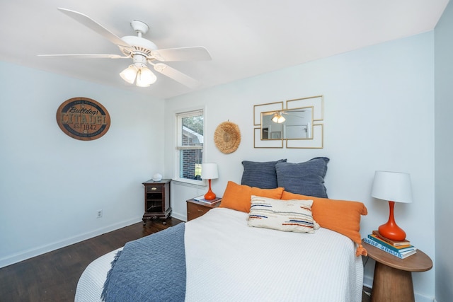 bedroom with ceiling fan, wood finished floors, and baseboards