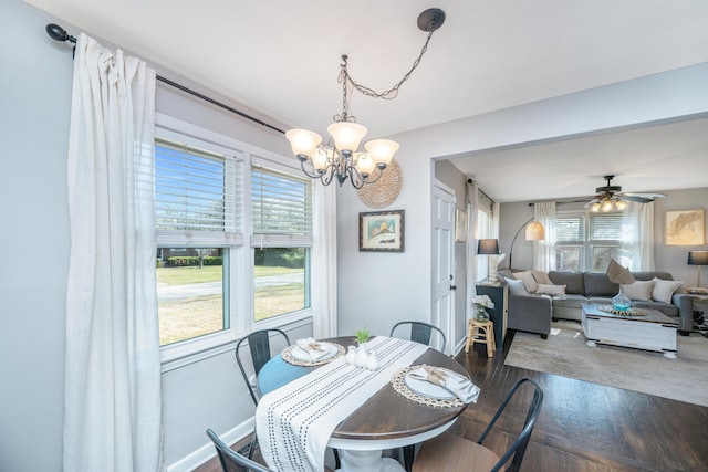 dining space with plenty of natural light, wood finished floors, and ceiling fan with notable chandelier