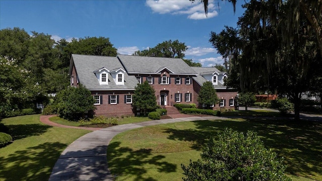 colonial inspired home with a front yard