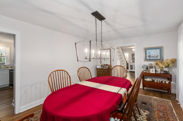 dining space featuring a notable chandelier and dark hardwood / wood-style floors