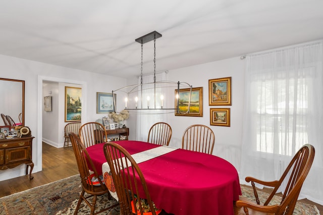 dining room featuring dark hardwood / wood-style flooring and a chandelier