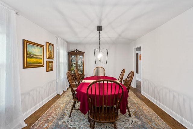 dining space featuring a chandelier and dark hardwood / wood-style flooring