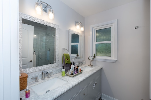 bathroom with vanity and a shower with door