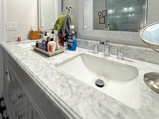 bathroom featuring vanity and an enclosed shower