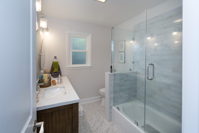 full bathroom featuring toilet, combined bath / shower with glass door, vanity, and tile patterned flooring