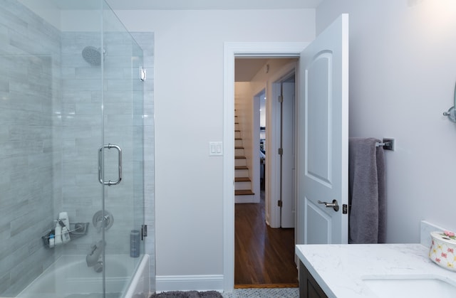 bathroom featuring shower / bath combination with glass door, vanity, and hardwood / wood-style flooring