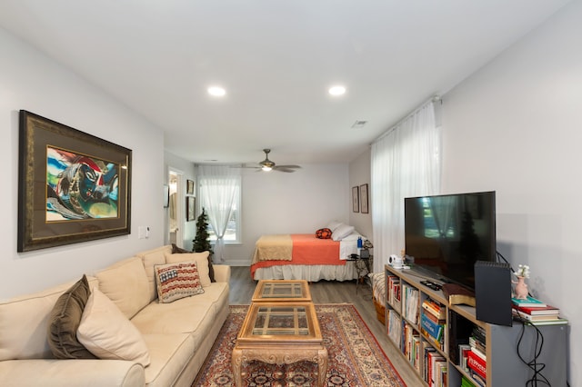 living room featuring hardwood / wood-style flooring and ceiling fan