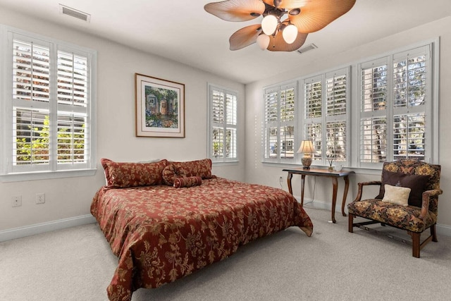 carpeted bedroom with multiple windows, baseboards, and ceiling fan