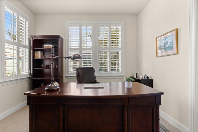 home office with baseboards, plenty of natural light, and carpet floors