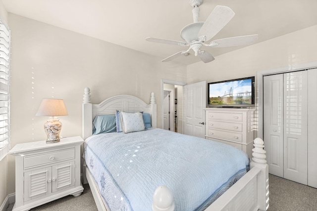 bedroom with light colored carpet, ceiling fan, and a closet