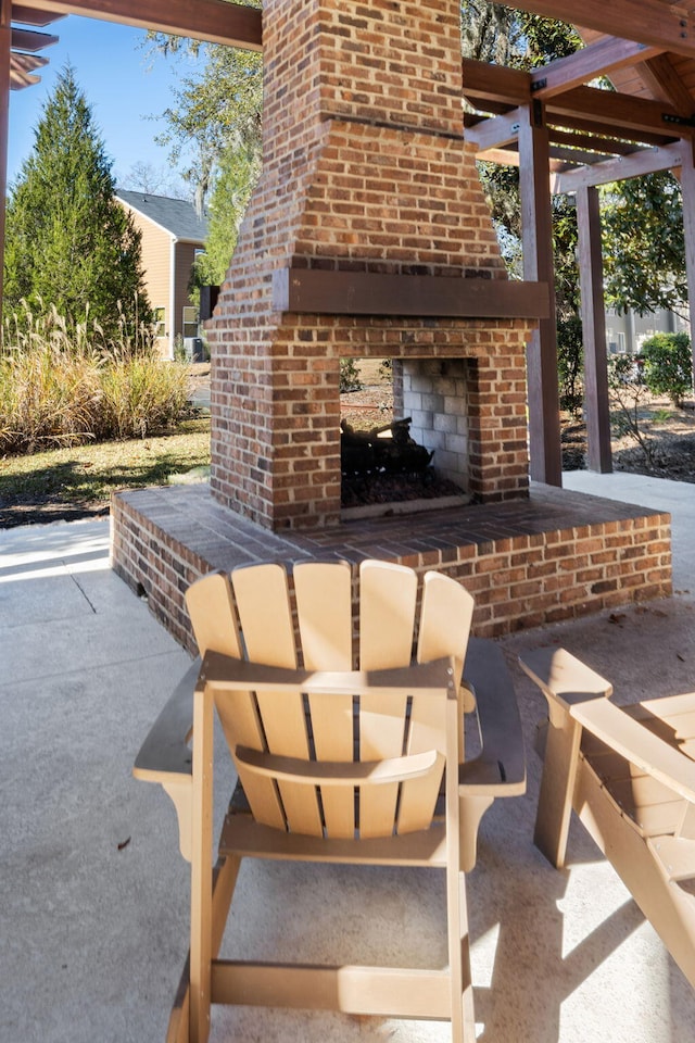 view of patio / terrace featuring an outdoor brick fireplace