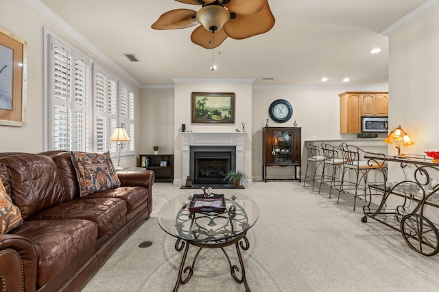 living room featuring ceiling fan, light colored carpet, crown molding, a fireplace with flush hearth, and recessed lighting