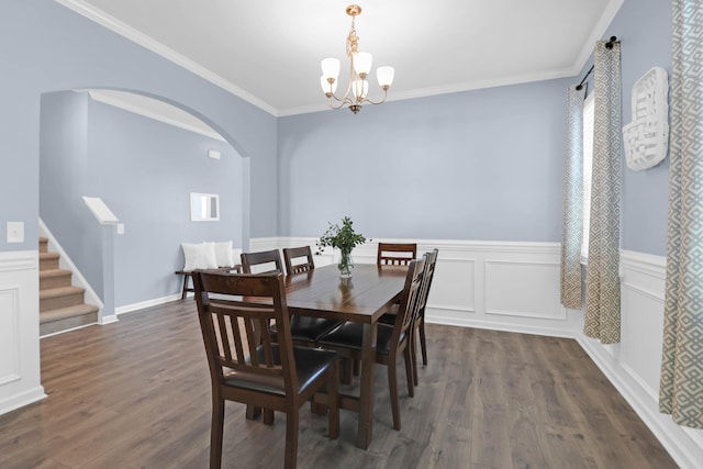 dining room featuring a notable chandelier, dark hardwood / wood-style flooring, and crown molding