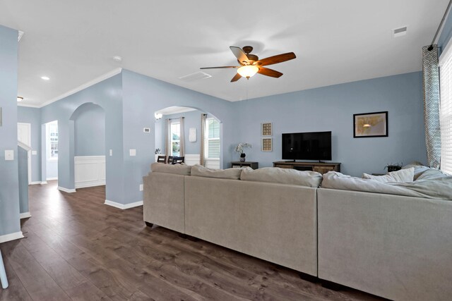 living room featuring crown molding, ceiling fan, and dark hardwood / wood-style floors