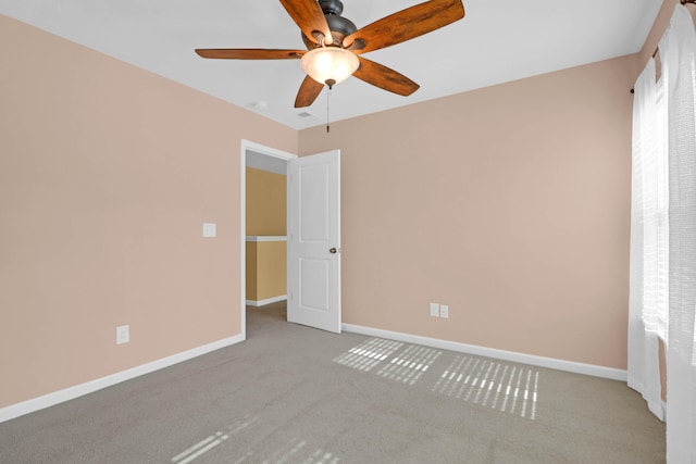 unfurnished room featuring light carpet and ceiling fan