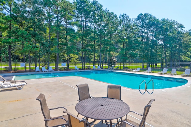 view of swimming pool featuring a patio area