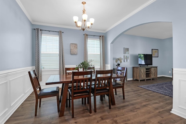 dining space featuring ornamental molding, dark wood-type flooring, and a notable chandelier