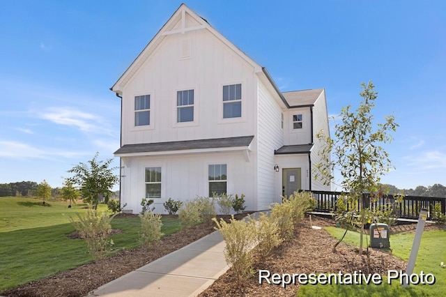 view of front of property with a wooden deck and a front yard