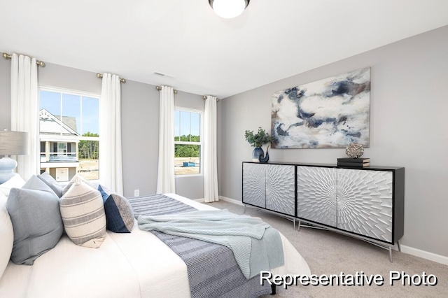 bedroom featuring light colored carpet