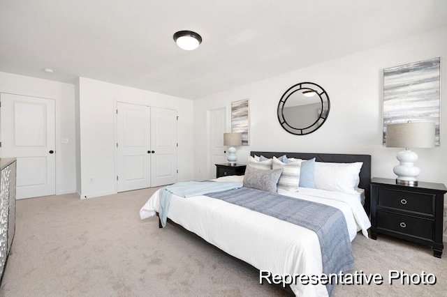 bedroom featuring light colored carpet and a closet