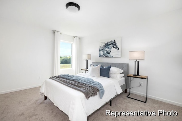 bedroom featuring light carpet