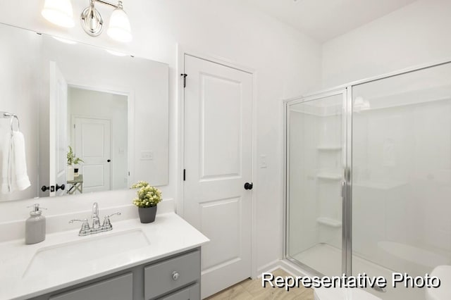 bathroom with vanity and a shower with door