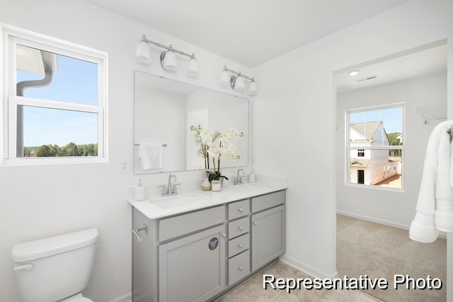 bathroom featuring vanity and toilet