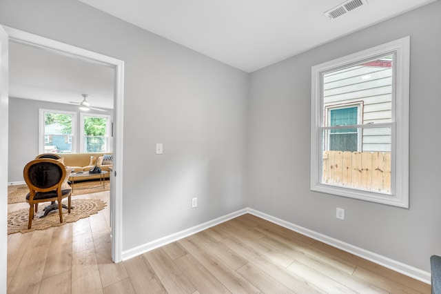 empty room featuring ceiling fan and light hardwood / wood-style floors