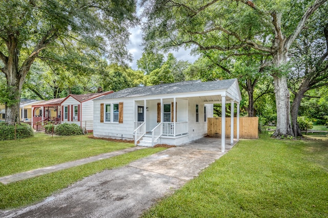 ranch-style house with a porch, a carport, and a front yard