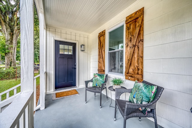 view of exterior entry featuring covered porch