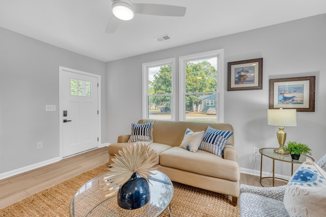 living room with wood-type flooring and ceiling fan